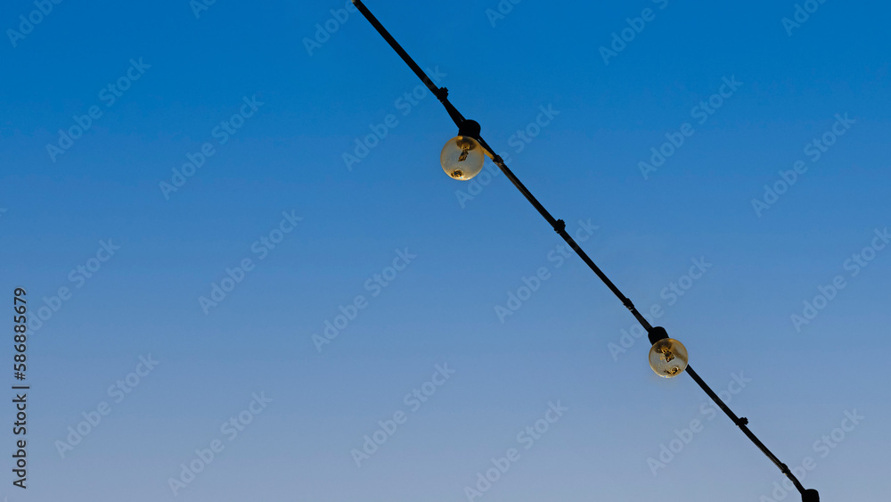Group of Light bulbs hanging on wires against on blue sky. Group of Light bulbs hanging on wires against on blue sky.