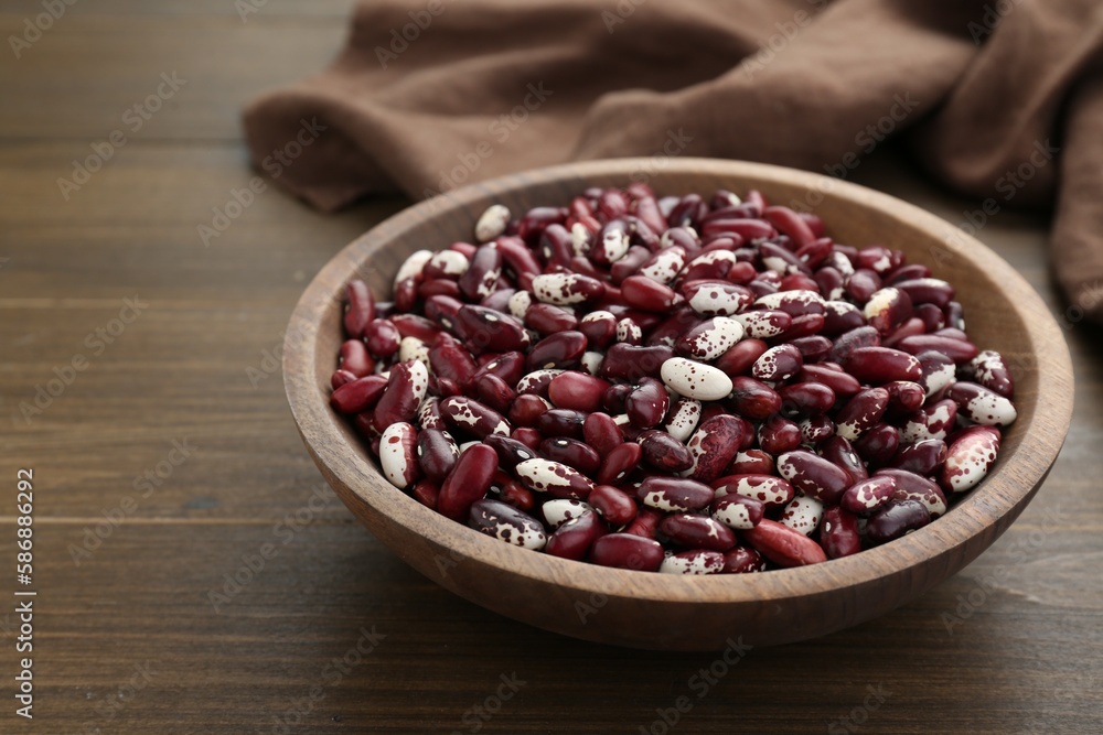 Bowl with dry kidney beans on wooden table Bowl with dry kidney beans on wooden table