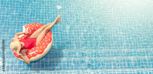 Beautiful woman with inflatable donut in pool