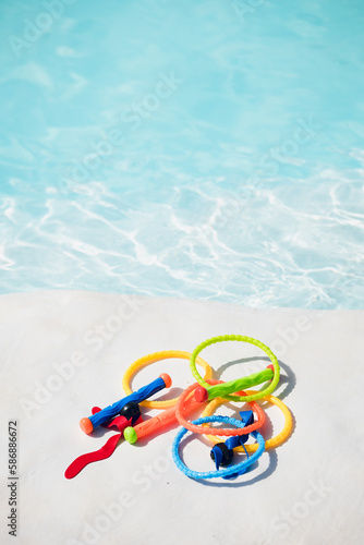 colorful toys for the water at the edge of the swimming pool