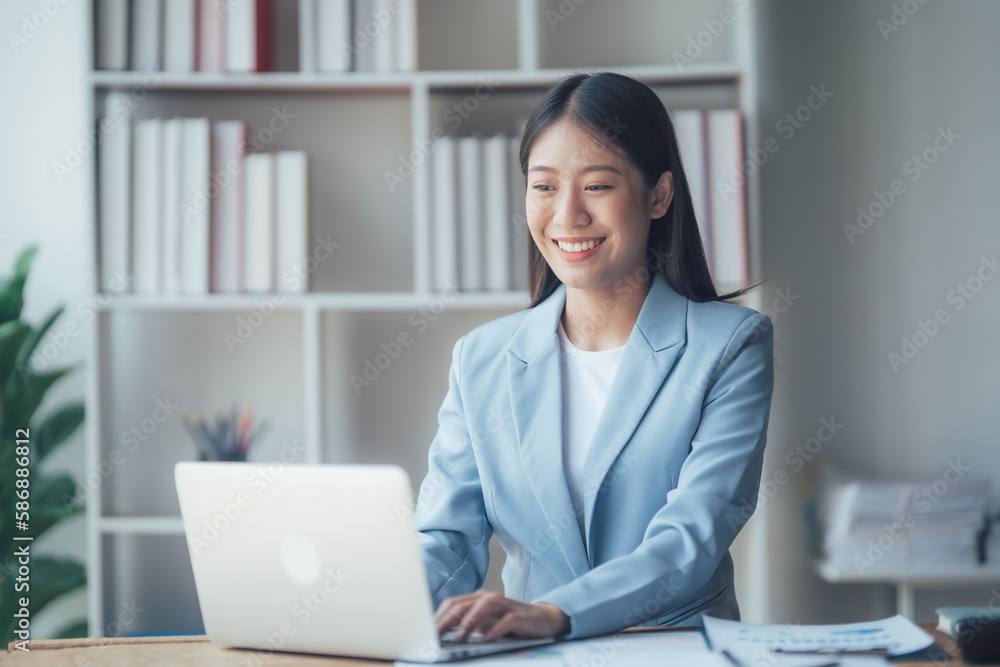 Asian businesswoman talking on phone, using laptop, looking at screen, entrepreneur manager consulting client by call, looking at computer screen, discussing Asian businesswoman talking on phone, using laptop, looking at screen, entrepreneur manager consulting client by call, looking at computer screen, discussing