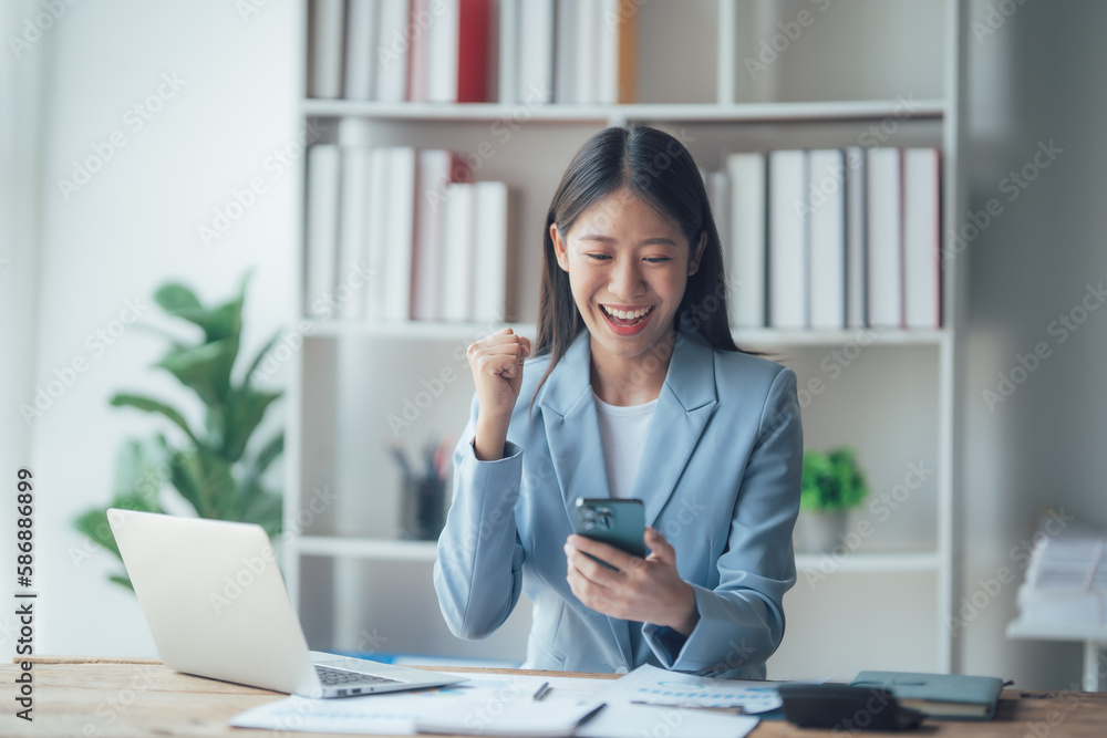 Asian businesswoman talking on phone, using laptop, looking at screen, entrepreneur manager consulting client by call, looking at computer screen, discussing Asian businesswoman talking on phone, using laptop, looking at screen, entrepreneur manager consulting client by call, looking at computer screen, discussing