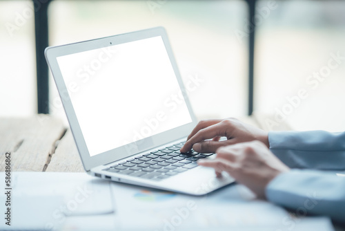 Asian businesswoman talking on phone, using laptop, looking at screen, entrepreneur manager consulting client by call, looking at computer screen, discussing