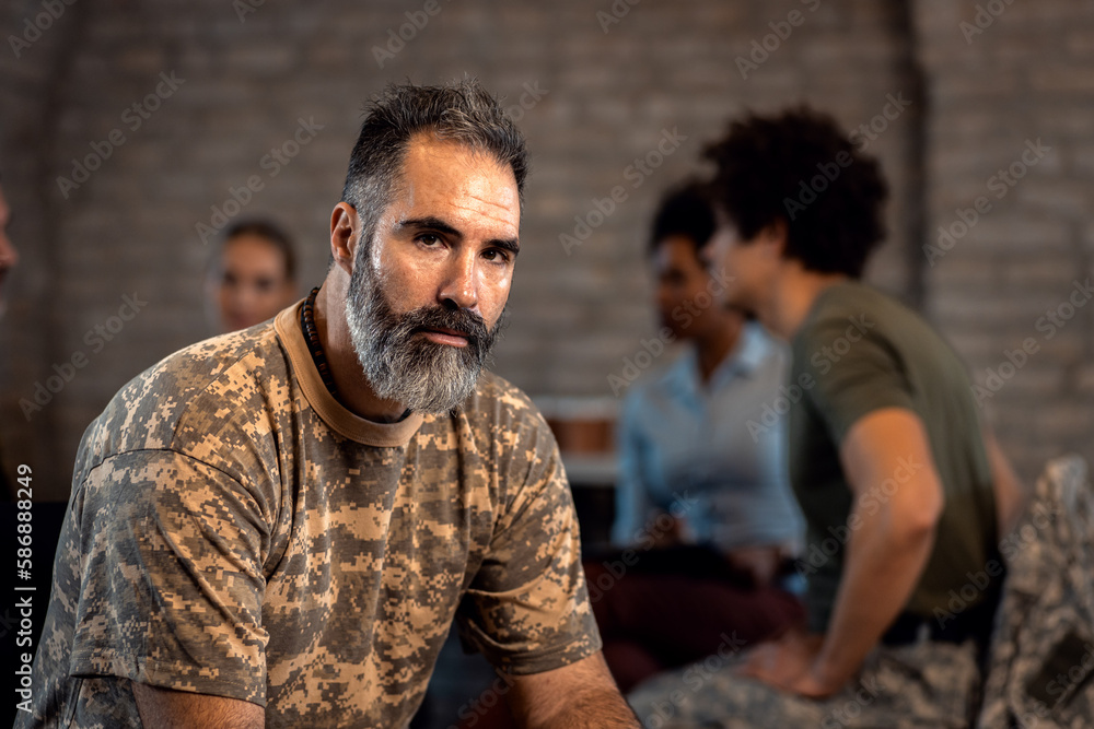 Portrait of male veteran in PTSD support group looking at camera. Portrait of male veteran in PTSD support group looking at camera.