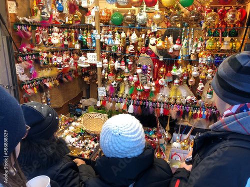 Shoppers browsing hand made glass christmas ornaments at the Christmas Market 