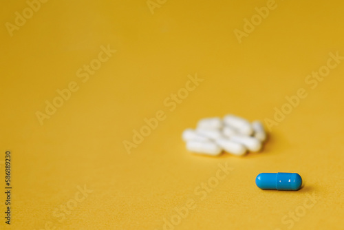 Heap of pills on yellow background. Concept of medicines and health care. vitamins or food supplemets. Top view, copy space, high resolution product. photo