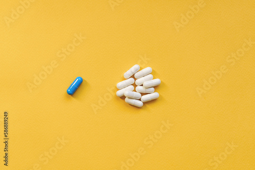 Heap of pills on yellow background. Concept of medicines and health care. vitamins or food supplemets. Top view, copy space, high resolution product. photo