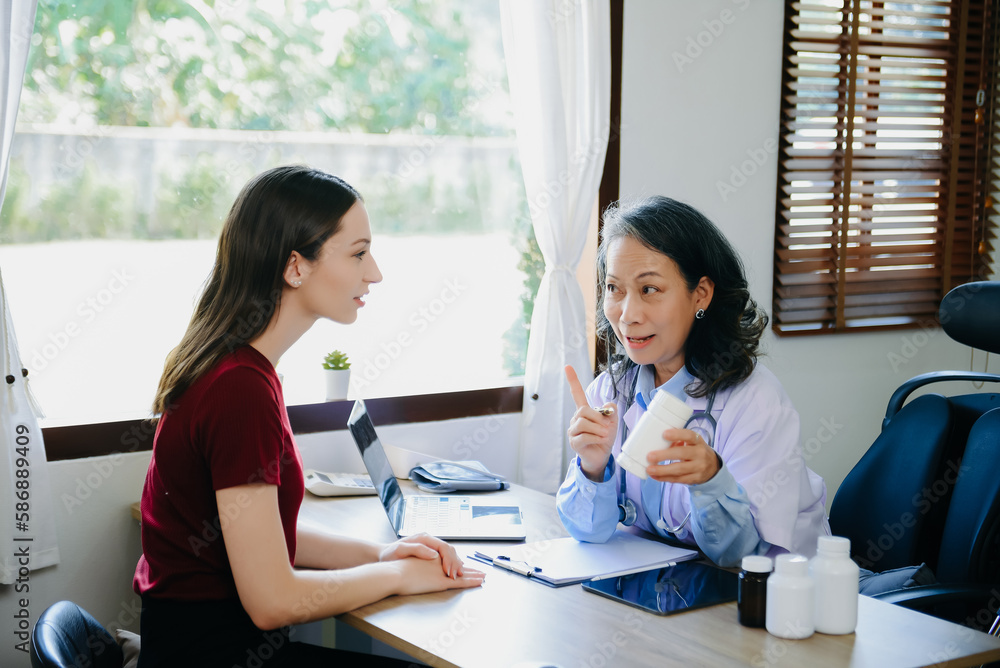 A physician talks to discuss results or symptoms and gives a recommendation to a male patient and signs a medical paper at an appointment visit in the clinic... A physician talks to discuss results or symptoms and gives a recommendation to a male patient and signs a medical paper at an appointment visit in the clinic...