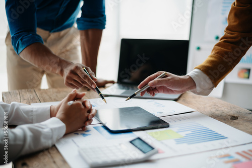 Business people meeting at office writing notes about sticky notes Laptop,tablet  Planning and Brainstorming Strategies of Colleagues