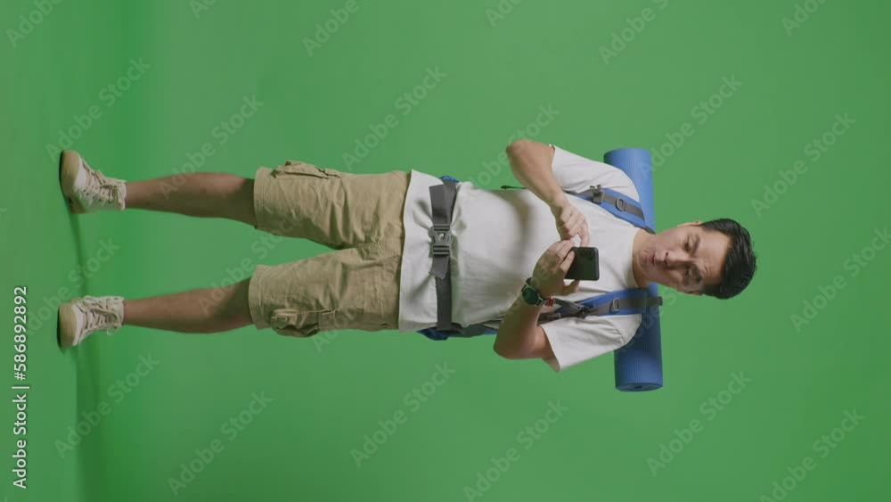 Full Body Of Asian Male Hiker With Mountaineering Backpack Looking At The Smartphone And Saying Wow While Standing On Green Screen Background In The Studio
Full Body Of Asian Male Hiker With Mountaineering Backpack Looking At The Smartphone And Saying Wow While Standing On Green Screen Background In The Studio