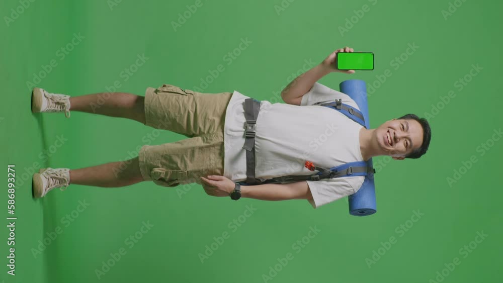 Full Body Of Asian Male Hiker With Mountaineering Backpack Smiling And Showing Mock Up Green Screen Smartphone While Standing On Green Screen Background In The Studio
Full Body Of Asian Male Hiker With Mountaineering Backpack Smiling And Showing Mock Up Green Screen Smartphone While Standing On Green Screen Background In The Studio