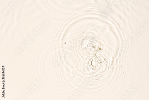 Water surface abstract background texture with splashes and bubbles. Beige color