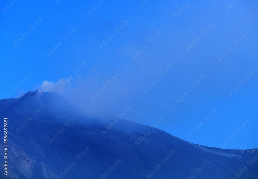 evocative image of the Etna volcano in Sicily with a blue sky
