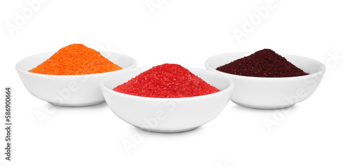 Bowls with food coloring on white background