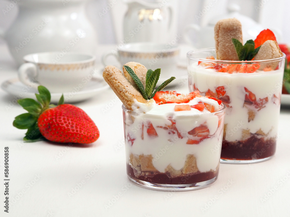 Dessert with mascarpone and whipped cream, savoiardi biscuit and fresh strawberry Dessert with mascarpone and whipped cream, savoiardi biscuit and fresh strawberry