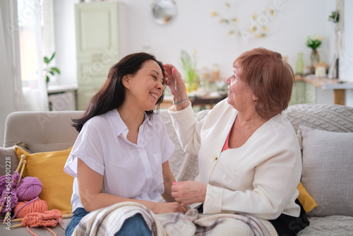 daughter talking and sharing news with her mother, indicating that they have an open and supportive communication style. importance of communication in building strong relationships.