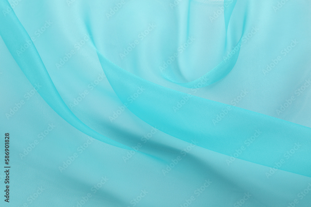 Obraz premium Beautiful turquoise tulle fabric as background, closeup