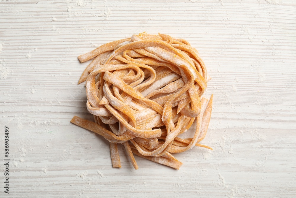 Pasta painted with food coloring and flour on white wooden table, top view Pasta painted with food coloring and flour on white wooden table, top view