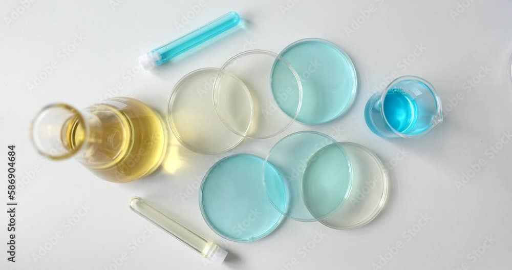 Laboratory glassware with blue and yellow liquid in lab. Scientific research of toxic substances Laboratory glassware with blue and yellow liquid in lab. Scientific research of toxic substances