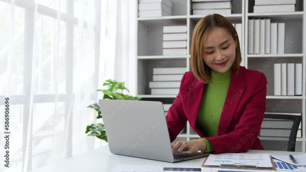 Business woman is working about new business project on laptop and raised your hands when finished work on project in office Business woman is working about new business project on laptop and raised your hands when finished work on project in office