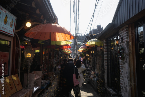 Photography Ikseondong Hanok Village , traditional walking street with umbrellas during wint