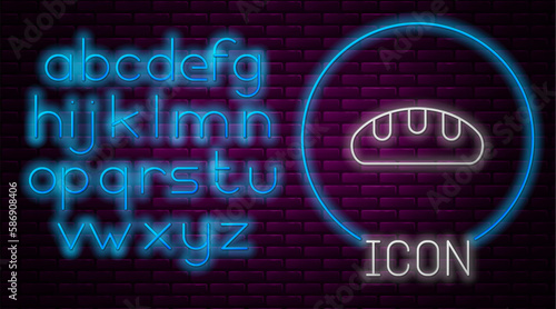 Glowing neon line Bread loaf icon isolated on brick wall background. Neon light alphabet. Vector