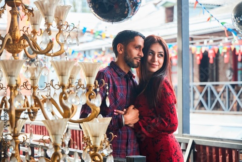 A beautiful Indian married couple is walking in a European city. A stylish place in the Urban style. Love and joyful relationships.