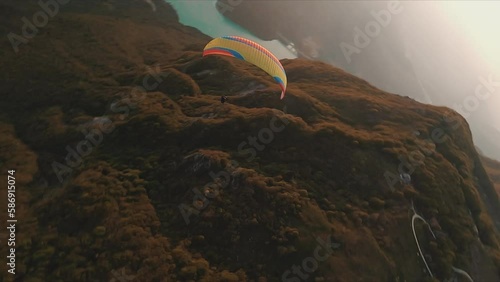 extreme fpv of a paraglider  over the mountain