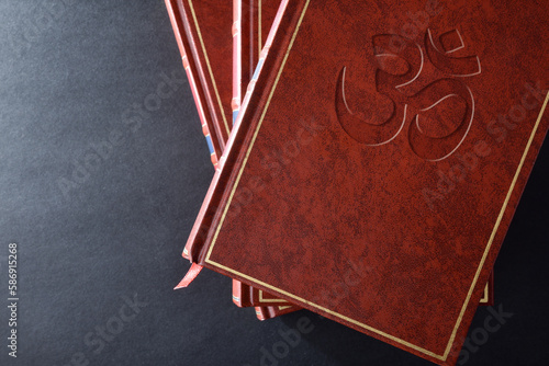 Fototapeta Naklejka Na Ścianę i Meble -  Stack of books with engraved symbol hindu top view