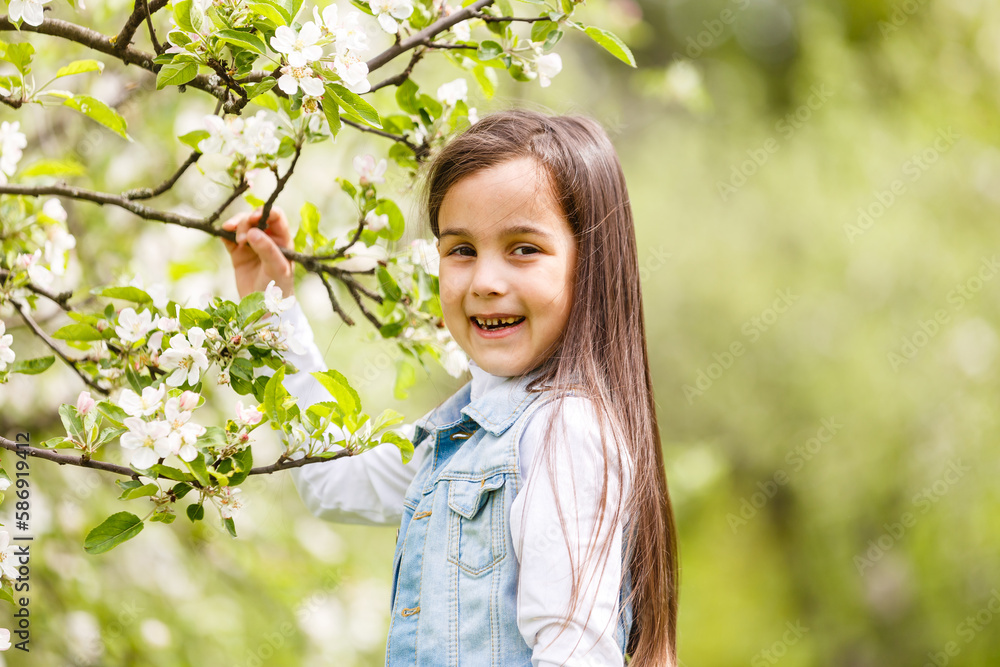 Beautiful little girl near the blossom tree Beautiful little girl near the blossom tree