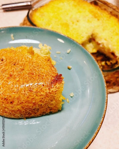 tahchin, baked rice with saffron, golden rice, browned and crispy saffron rice, dish from the Far East, baked rice on a plate