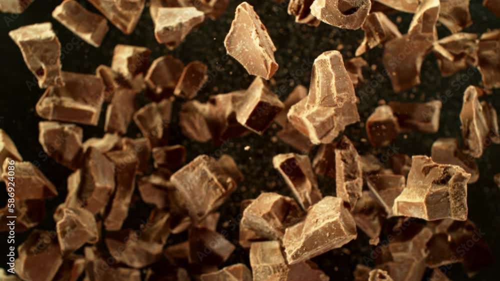 Super slow motion of rotating group of raw chocolate pieces. Super fast camera motion. Filmed on high speed cinema camera, 1000fps, placed on high speed cine bot. Speed ramp effect. Super slow motion of rotating group of raw chocolate pieces. Super fast camera motion. Filmed on high speed cinema camera, 1000fps, placed on high speed cine bot. Speed ramp effect.