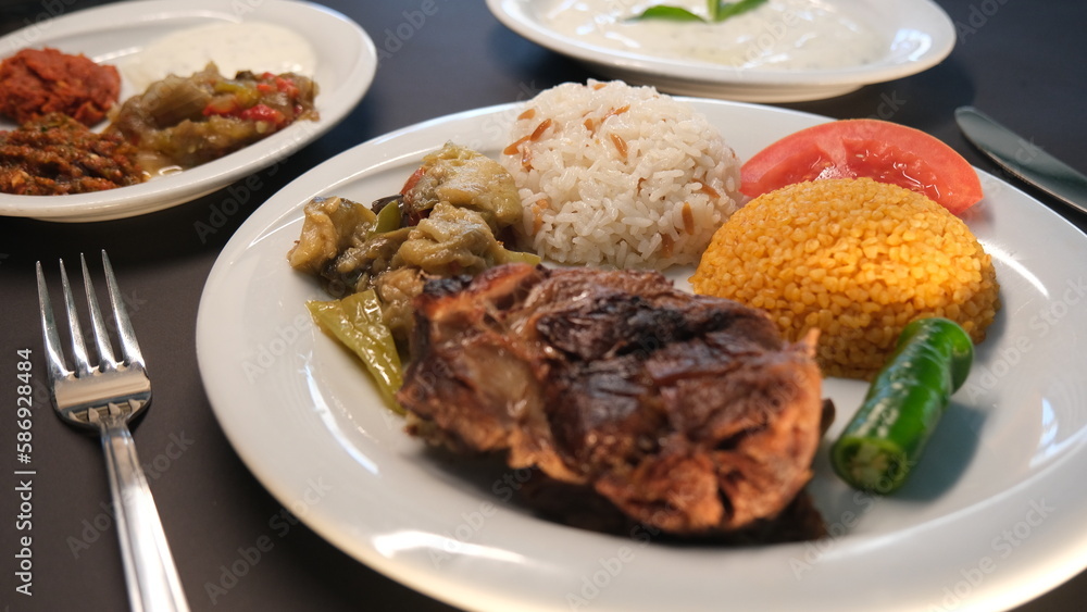 Beef breast ribs served with rice and appetizers on a serving plate Beef breast ribs served with rice and appetizers on a serving plate