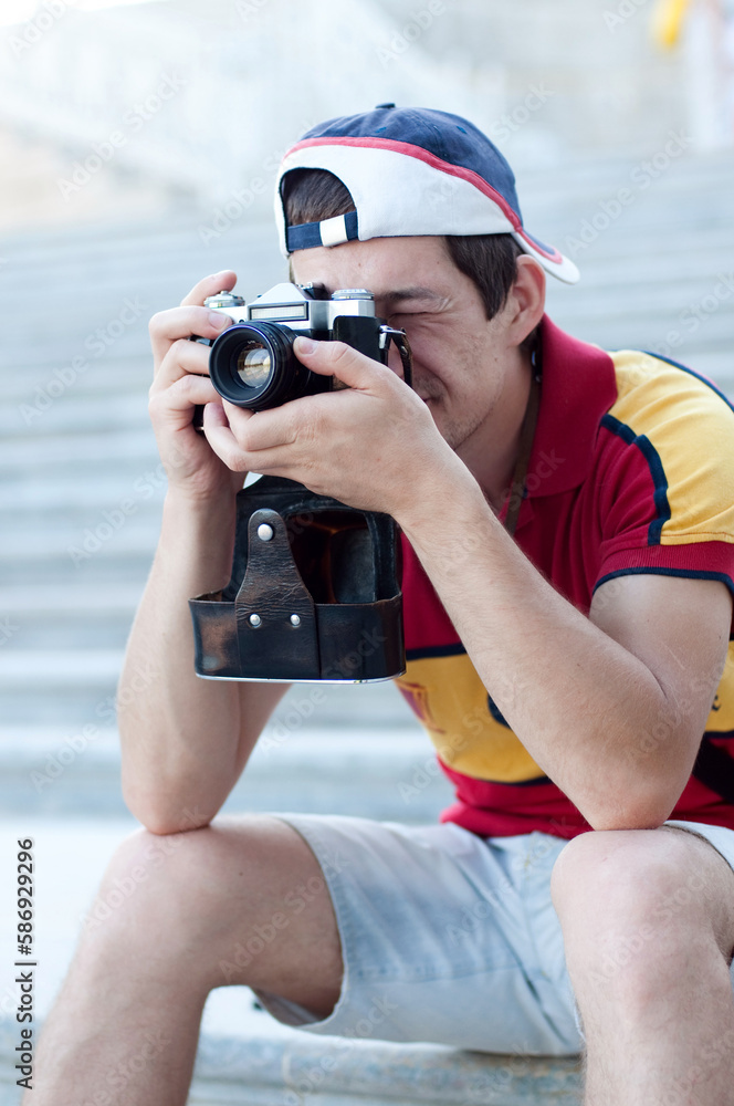 Tourist man with retro photo camera, student photographer. Trip, tourism