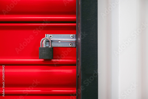Padlock of self storage door with red door photo