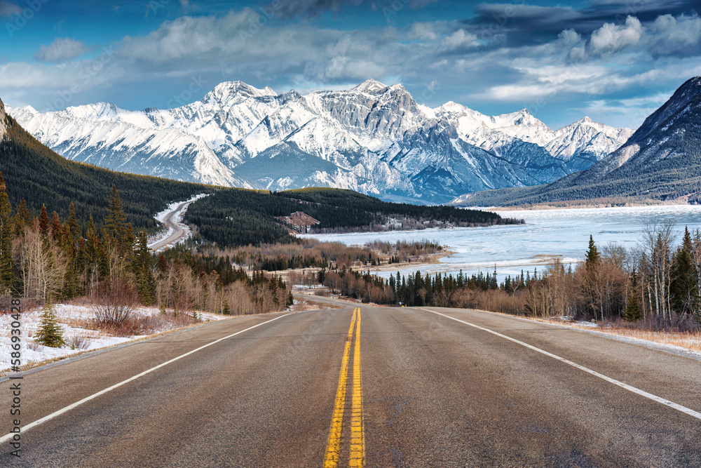 Scenery of Road trip on highway with rocky mountains and frozen lake at Icefields Parkway