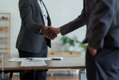 african american and asian people hand shaking successful corporate partnership deal welcoming opportunity in office agreement professional greeting meeting colleagues partners