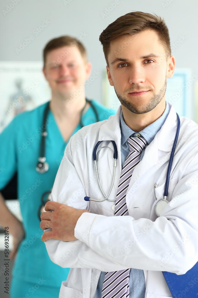 Portrait of two men in healthcare profession. Team of cardiologists therapists or surgeons Portrait of two men in healthcare profession. Team of cardiologists therapists or surgeons