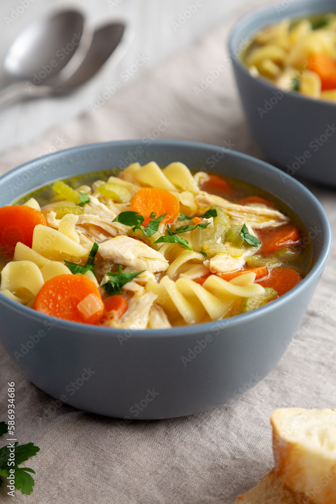 Homemade Chicken Noodle Soup in a Bowl, low angle view. Close-up. Homemade Chicken Noodle Soup in a Bowl, low angle view. Close-up.
