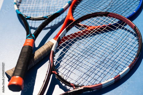 broken tennis rackets on clay tennis court