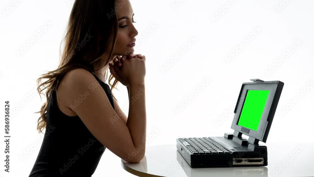 Female on a computer with green screen Female on a computer with green screen