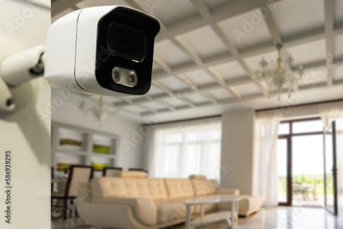 Close Up Object Shot of a Modern Wi-Fi Surveillance Camera with Two Antennas on a White Wall in a Cozy Apartment Has Wi-Fi Icon Above it.