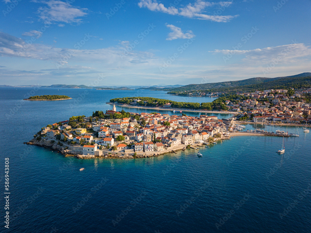 Aerial view of Primosten old town on the islet, Dalmatia, Croatia. Scenic seascape and city with medieval architecture, famous tourist resort on Adriatic sea coast, outdoor travel background