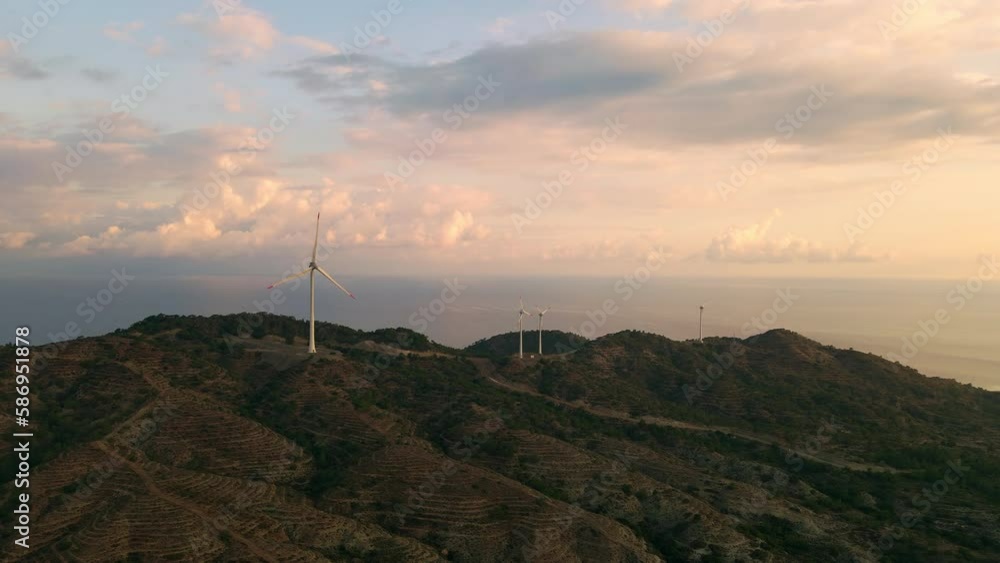 Aerial view of windmill turbines generating green energy electric, Establishing shot Aerial view of windmill turbines generating green energy electric, Establishing shot