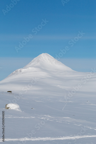 Snow-covered mountain with blue skies