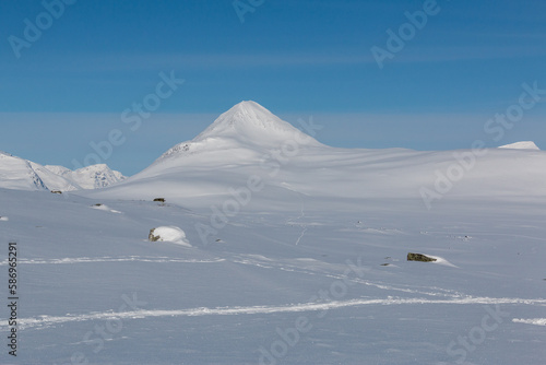 Snow-covered mountain with blue skies