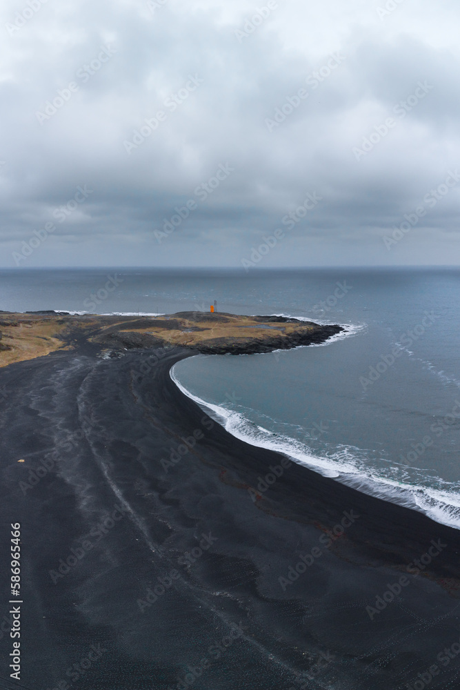 Drone view of road with lighthouse on beach Drone view of road with lighthouse on beach
