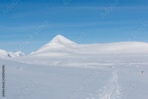 Snow-covered mountain with blue skies