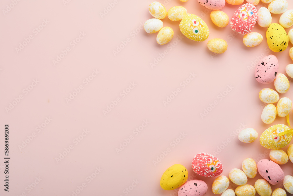 Happy Easter. Easter eggs and white rabbit decoration isolated on trendy pastel pink background with white and yellow roses. Spring Happy Easter holiday card and mock up background. Top view flat lay.