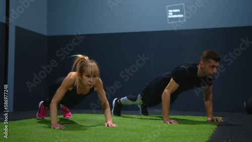 A young couple trains in the gym doing modern exercises to improve their figure and take care of their health. Healthy eating and exercise prolong life photo